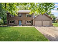 Charming two-story home with a well-manicured lawn, blue front door, and an attached two-car garage at 4967 Jett Rd, Marietta, GA 30066