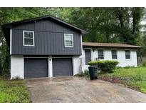 Charming two-story home with a well-maintained yard and a two car garage at 586 Chris Cir, Lawrenceville, GA 30044