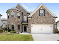 Charming two-story brick home featuring an attached two-car garage and manicured front lawn at 829 Overlook Path Ln, Lawrenceville, GA 30045
