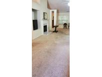 Living room features a fireplace, TV, and natural light through large windows at 999 Simonton Glen Dr, Lawrenceville, GA 30045