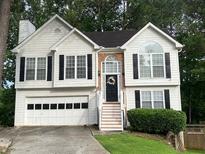 Charming two-story home featuring white siding, black shutters, and an attached two-car garage at 340 Fountainmist Trl, Lawrenceville, GA 30043