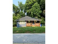 Charming single-story home features a welcoming front porch and a well-manicured lawn at 2319 Beecher Sw Rd, Atlanta, GA 30311