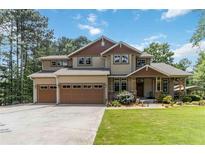 Charming two-story home with a manicured lawn, a two-car garage, and beautiful landscaping at 1268 Harris Road Rd, Lawrenceville, GA 30043