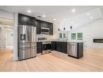 Modern kitchen features stainless steel appliances, black cabinets and an island with a sink at 3052 Brook Dr, Decatur, GA 30033