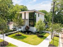 Stunning modern home showcasing a lush landscaped yard and architectural design at 3117 Robinson Ave, Scottdale, GA 30079