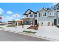 Beautiful two-story homes featuring attached garages, landscaped yards, and modern architectural details at 776 Woodstock Grove Dr, Woodstock, GA 30188