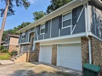 Split-level home boasts a two-car garage and brick facade, providing both convenience and classic curb appeal at 3975 Northstrand Dr, Decatur, GA 30035