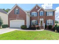 Charming two-story brick home with a well-manicured lawn and a two-car garage at 851 Roget Ct, Lawrenceville, GA 30045