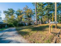 Charming home with a manicured lawn and a welcoming mailbox. Houses are located close together at 1555 Rupert Rd, Decatur, GA 30032
