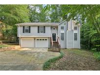 Charming two-story home with a two-car garage and a welcoming front entrance with wooden stairs at 2920 Cushing Ct, Jonesboro, GA 30236