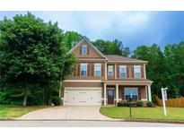 Inviting two-story home with brown siding, shutters, a well-manicured lawn and a two car garage at 60 Copeland Trce, Dallas, GA 30157