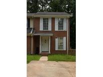 Two-story brick townhouse with white shutters and a covered entryway at 852 Glynn Oaks Dr, Clarkston, GA 30021