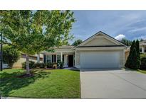 Charming single-story home with a well-manicured lawn, inviting curb appeal, and a two-car garage at 110 Baltusrol Way, Covington, GA 30014