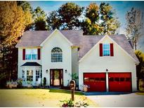 Charming two-story home with a well-manicured lawn, red garage doors, and inviting curb appeal at 475 Cascade Rise, South Fulton, GA 30331