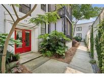Charming building entrance with a red front door and landscaped walkway at 68 Peachtree Memorial Nw Dr # 68-1, Atlanta, GA 30309