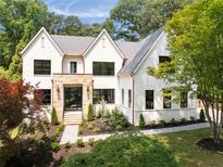Stunning two-story home with a white brick exterior, stone accents, and professionally landscaped front yard at 3292 Lenox Ne Pl, Atlanta, GA 30324