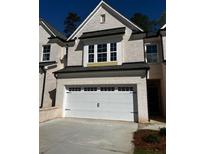 Charming two-story home with a white brick exterior, a two-car garage, and a neatly manicured lawn at 4160 Cavalier Way, Duluth, GA 30097