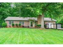 Charming brick home featuring a well-manicured lawn and mature trees for shade and curb appeal at 2884 Bent Creek Nw Dr, Kennesaw, GA 30152