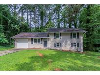 Charming split-level home with a well-maintained lawn and an attached garage at 1539 Pine Glen Cir, Decatur, GA 30035