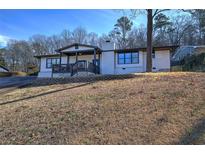 Charming single-story home with a brick facade and inviting front porch, nestled on a sunny lot at 52 Buena Vista Se Cir, Cartersville, GA 30121