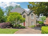 Charming two-story home with a well-manicured front yard and inviting curb appeal at 11880 Wexford Club Dr, Roswell, GA 30075
