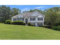 Charming two-story home with manicured lawn and traditional architectural details at 100 Chestnut Hill Dr, Canton, GA 30114