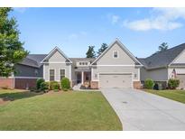 Charming single-Gathering home features a two-car garage, well-manicured lawn, and inviting front porch at 2245 Long Bow Chase, Kennesaw, GA 30144