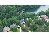 Stunning aerial view of lakefront homes surrounded by lush greenery and a private dock at 1515 Lockridge Dr, Cumming, GA 30041