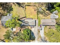 Expansive aerial view showcasing the home's placement in a tree-lined community with a spacious yard at 1755 Fairburn Sw Rd, Atlanta, GA 30331