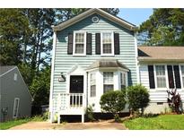 Charming two-story home featuring blue siding, black shutters, and a well-manicured front yard at 775 Heritage Valley Rd, Norcross, GA 30093