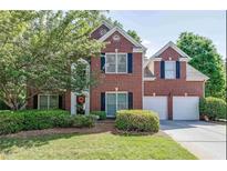 Charming two-story brick home with a well-manicured lawn and a two-car garage at 1008 Post Horn Run, Lawrenceville, GA 30045