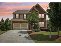 Charming two-story brick home with a well-manicured lawn and a two-car garage at 4480 Egret Ave, Cumming, GA 30041