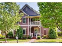 Charming two-story home with a cozy front porch and beautifully landscaped front yard at 1517 Gilstrap Nw Ln, Atlanta, GA 30318