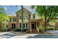 Charming brick townhome with a covered porch and landscaped front yard in a desirable neighborhood at 2010 Riverside Rd, Roswell, GA 30076