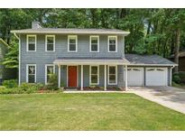 Charming two-story home features a well-manicured lawn, complemented by a covered entryway and a two-car garage at 4772 Ridgewood Nw Ct, Acworth, GA 30102