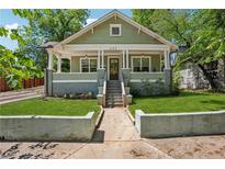 Charming green craftsman-style home with manicured front lawn and inviting front porch at 642 Erin Sw Ave, Atlanta, GA 30310