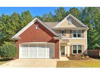 Charming home featuring a brick facade, neutral siding, well-manicured landscaping, and an attached two-car garage at 125 Redsage Rdg, Atlanta, GA 30349