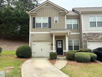 Charming two-story townhome with attached garage and manicured landscaping at 2575 Maple Park Pl # 20, Cumming, GA 30041