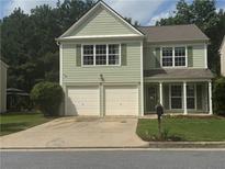 Charming two-story home featuring a two-car garage and a well-maintained lawn at 186 Wallnut Hall Cir, Woodstock, GA 30189