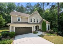 Charming two-story home with a two-car garage and well-manicured landscaping at 2740 Creekside Manor Dr, Powder Springs, GA 30127