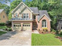 Charming two-story home featuring a brick and siding facade, two-car garage, and a well-manicured front lawn at 3535 Fairgreen Ct, Douglasville, GA 30135