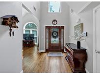 Bright foyer features a high ceiling, hardwood floors, and a decorative glass front door at 3535 Fairgreen Ct, Douglasville, GA 30135