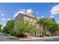 Charming brick townhouse with attached two car garage and manicured landscaping at 11259 Calypso Dr, Alpharetta, GA 30009