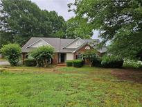 Charming single-story home featuring a brick facade and mature landscaping at 3502 Tiffany Se Dr, Conyers, GA 30013