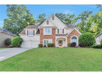Charming two-story home with manicured lawn, stone accents, and a two-car garage at 4360 Canterbury Walk Dr, Duluth, GA 30097
