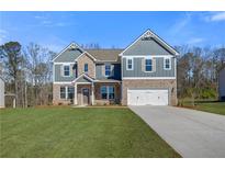 Beautiful two-story home with brick and siding, complemented by a well-manicured lawn at 120 Felicity Pike, Locust Grove, GA 30248