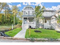 Charming two-story home with a welcoming front porch and a well-manicured lawn at 1697 Thomas St, Decatur, GA 30032