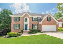 Beautiful two-story brick home with well-manicured lawn and attached two car garage at 1765 Pinetree Pass Lane Southwest Sw Ln, Lilburn, GA 30047