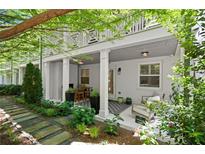Relaxing back porch with seating, outdoor dining, and decorative plants at 420 Banbury Xing, Alpharetta, GA 30009