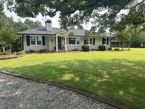 Charming brick home with a well-manicured lawn and mature trees offers great curb appeal at , Social Circle, GA 30025